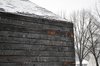 Snow falls on charred wood, creating a striking contrast. Photo 8 of Warming Hut modern home
