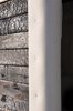The exterior of the Smokehouse is clad in charred cedar and its black form stands in sharp contrast to the white snow and ivory felt. Burning the planks over a fire in a metal waste bin, a technique used in Japan for thousands of years, yields a crispy black crust, stabilizing the wood and making it rot, pest and fire-resistant. Photo 4 of Warming Hut modern home