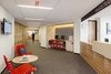 Modern home with Office, Study Room Type, Chair, Library Room Type, Desk, and Carpet Floor. The design strategy converted the existing double loaded corridor into a welcoming and dynamic public space connecting two reception areas, two student computer kiosks, staff break room and focus rooms. Photo of Harvard Student Services