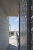 Modern home with Exterior, Metal Siding Material, Wood Siding Material, House Building Type, and Concrete Siding Material. Water jets were used to create the screen's floral pattern, which casts intricate shadows that "move through the house as the day unfolds". Photo 6 of Hamptons Beach House