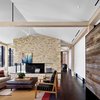 Modern home with Living Room, Chair, Standard Layout Fireplace, Rug Floor, Sofa, Recessed Lighting, Dark Hardwood Floor, and Coffee Tables. New York designer Bella Mancini scoured Austin shops such as Spartan and Mockingbird Domestics for the relaxed mix of furniture and accessories. Photo of Modern Texas Prefab