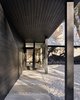 The two wings are each clad in a different material. One is clad in white stucco, while the other has walls of charred cedar, giving the house a monochrome exterior. Photo 4 of Modern Texas Prefab modern home