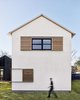 Offset by a white steel roof, the charred wood and white stucco exterior gives way to modern interiors that feature reclaimed timber, local limestone, and raw steel. Photo 6 of Modern Texas Prefab modern home