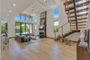 Modern home with Living Room, Sofa, Chair, Sectional, End Tables, Ceiling Lighting, Coffee Tables, Floor Lighting, Recessed Lighting, Light Hardwood Floor, Gas Burning Fireplace, and Standard Layout Fireplace. Front Entry Main Living Area Photo 3 of The Rosewood Residence