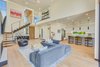 Modern home with Living Room, Chair, Ottomans, Sofa, Coffee Tables, End Tables, Sectional, Ceiling Lighting, Floor Lighting, Recessed Lighting, Light Hardwood Floor, Wall Lighting, Standard Layout Fireplace, and Gas Burning Fireplace. Main Living Area Photo 4 of The Rosewood Residence