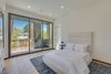 Modern home with Bedroom, Table Lighting, Ceiling Lighting, Bed, Recessed Lighting, and Light Hardwood Floor. Front Bedroom Photo 14 of The Rosewood Residence