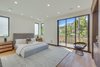 Modern home with Bedroom, Bed, Storage, Night Stands, Chair, Ceiling Lighting, Table Lighting, Accent Lighting, and Light Hardwood Floor. Master Suite Photo 18 of The Rosewood Residence