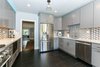 Modern home with Kitchen, Marble Counter, Colorful Cabinet, Wood Cabinet, Dark Hardwood Floor, Ceramic Tile Backsplashe, Mosaic Tile Backsplashe, Ceiling Lighting, Recessed Lighting, Refrigerator, Pendant Lighting, Accent Lighting, Dishwasher, Range, Cooktops, Beverage Center, Ice Maker, and Undermount Sink. View of kitchen from laundry nook Photo 4 of Lincoln Kitchen