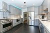 Modern home with Kitchen, Wood Cabinet, Colorful Cabinet, Marble Counter, Dark Hardwood Floor, Ceramic Tile Backsplashe, Pendant Lighting, Accent Lighting, Ceiling Lighting, Refrigerator, Recessed Lighting, Microwave, Cooktops, Range, Dishwasher, Ice Maker, Beverage Center, Range Hood, and Undermount Sink. View of smart kitchen customizable LED cabinet lights and pendant. Photo 5 of Lincoln Kitchen