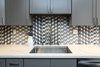 Modern home with Kitchen, Marble Counter, Colorful Cabinet, Ceramic Tile Backsplashe, Wood Cabinet, Mosaic Tile Backsplashe, and Undermount Sink. Close up of "Grey Dawn" countertops, and Grohe faucet. Photo 7 of Lincoln Kitchen