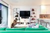 Modern home with Living Room, Bookcase, Sofa, Coffee Tables, Chair, Console Tables, Floor Lighting, and Vinyl Floor. Straight on view of living area. Photo of California Street Home