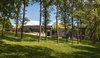Modern home with Outdoor, Back Yard, Slope, Woodland, Trees, Hardscapes, Gardens, Raised Planters, Flowers, and Concrete Patio, Porch, Deck. View from Sunfish Lake Photo 2 of Sunfish Lake Residence