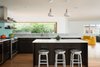 Modern home with Kitchen, Engineered Quartz Counter, Granite Counter, Wood Cabinet, Glass Tile Backsplashe, Ceiling Lighting, Pendant Lighting, Refrigerator, Wine Cooler, Range Hood, Range, Dishwasher, and Undermount Sink. Kitchen Photo 11 of 20th Street