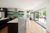 Modern home with Kitchen, Wood Cabinet, Granite Counter, Engineered Quartz Counter, Glass Tile Backsplashe, Ceiling Lighting, Pendant Lighting, Range, Range Hood, Refrigerator, Wine Cooler, Dishwasher, and Undermount Sink. Kitchen Photo 12 of 20th Street