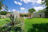 Modern home with Outdoor, Front Yard, Concrete Patio, Porch, Deck, Stone Fences, Wall, Grass, and Landscape Lighting. Front of Casa Sisal from pond Photo 3 of Casa Sisal