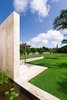Modern home with Exterior, Flat RoofLine, Stucco Siding Material, and House Building Type. Looking out from pond to great lawn and hacienda chimney Photo 4 of Casa Sisal