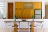 Modern home with Dining Room, Ceiling Lighting, Table, Medium Hardwood Floor, and Chair. Dining room table with kitchen behind Photo 5 of Casa Sisal