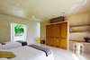 Modern home with Bedroom, Concrete Floor, Wardrobe, Chair, Bed, Accent Lighting, Ceiling Lighting, and Shelves. Guest bedroom Photo 10 of Casa Sisal