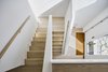 Modern home with Staircase, Wood Tread, and Wood Railing. With the living/dining and kitchen moved to the upper level, the stair is an important feature in connecting the entry level with that above. Photo 6 of Arlington Solar