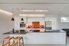 Modern home with Kitchen, Dishwasher, White Cabinet, Light Hardwood Floor, Wall Oven, Cooktops, Glass Tile Backsplashe, Recessed Lighting, Granite Counter, Refrigerator, Pendant Lighting, and Undermount Sink. Appliances include Bosch and Fisher Paykel. Photo 11 of Arlington Solar