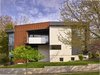 Modern home with Exterior, Metal Siding Material, House Building Type, Glass Siding Material, Flat RoofLine, and Stucco Siding Material. The living space has been elevated to the upper level and with an overlook balcony, connects the inhabitants to nature while being removed from the active street life. Photo 3 of Arlington Solar