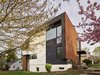 Modern home with Exterior, Metal Siding Material, Glass Siding Material, House Building Type, Flat RoofLine, and Stucco Siding Material. Exterior materials are comprised of corten and stucco (EIFS). Color is used to animate the composition. Photo 2 of Arlington Solar