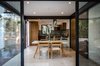 Modern home with Kitchen, Granite Counter, Wood Cabinet, Stone Slab Backsplashe, Travertine Floor, and Ceiling Lighting. Dinning and kitchen Photo 5 of CQ12