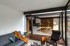 Modern home with Living Room, Travertine Floor, Sofa, Dark Hardwood Floor, Ceiling Lighting, and Recliner. Living room Photo 11 of CQ12