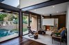 Modern home with Living Room, Ceiling Lighting, Travertine Floor, Dark Hardwood Floor, Sofa, Standard Layout Fireplace, and Wood Burning Fireplace. Living room Photo 14 of CQ12