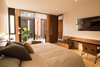 Modern home with Bedroom, Bed, Lamps, Chair, Bench, Ceiling Lighting, Marble Floor, and Travertine Floor. Bedroom Photo 8 of Casa Chaaltun