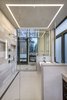 Modern home with Bath Room, Porcelain Tile Floor, Ceiling Lighting, Wall Lighting, Porcelain Tile Wall, Two Piece Toilet, Engineered Quartz Counter, Freestanding Tub, and Enclosed Shower. The thoughtful selection of lighting and materials fashions a spa like oasis. Photo 8 of Two Creeks