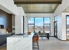 Modern home with Kitchen, Ceiling Lighting, Pendant Lighting, Cooktops, Wall Oven, Wood Cabinet, Undermount Sink, Medium Hardwood Floor, Marble Counter, and Stone Slab Backsplashe. The generous kitchen, living, and dining room space boasts high ceilings and large openings to the views and an outdoor living space beyond. Photo 7 of Terrace Drive