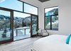 Modern home with Bedroom, Medium Hardwood Floor, Chair, and Bed. The entire third story is dedicated to the master suite complete with an en suite bath, private deck, and an adjacent office. Photo 11 of Terrace Drive
