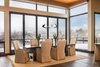 Modern home with Dining Room, Table, Chair, Ceiling Lighting, Pendant Lighting, and Medium Hardwood Floor. When open, the folding wall blurs the distinction beside inside and outside. Photo 7 of Two Creeks