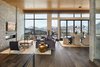 Modern home with Living Room, Ceiling Lighting, End Tables, Coffee Tables, Medium Hardwood Floor, Ribbon Fireplace, Chair, Pendant Lighting, and Sofa. The grand entry opens onto to the spacious great room with sizable windows, and a 16-foot folding wall system out to a deck ideal for entertaining or even stargazing. Photo 3 of Two Creeks
