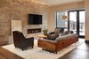 Modern home with Living Room, Rug Floor, Chair, Sofa, Medium Hardwood Floor, Ceiling Lighting, Coffee Tables, and Ribbon Fireplace. A generous family room downstairs with game area and kitchenette contributes to a family friendly environment. Photo 14 of Two Creeks