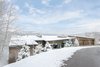 Modern home with Exterior, Shed RoofLine, Stone Siding Material, Metal Roof Material, House Building Type, and Wood Siding Material. Situated above the Two Creeks base area in the ski town of Snowmass Village, Colorado, this ski-in, ski-out residence is a skier’s paradise. This elegant home is 6,300 square feet sprawled across two levels with views for miles. Photo of Two Creeks