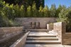 Entry walkway has stacked limestone walls and linear water features. Photo 3 of Ross Modern modern home