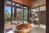 Master batheroom walls are of full slab stone. This Koa tub was hand made in Europe Photo 15 of Ross Modern modern home