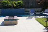 Modern home with Outdoor, Back Yard, Raised Planters, Hardscapes, Swimming Pools, Tubs, Shower, Stone Patio, Porch, Deck, and Tile Patio, Porch, Deck. travertine, slate and glass time create a stunning focal point in the pool. Photo of Modern Elegance