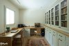 Modern home with Office, Library Room Type, Bookcase, Craft Room Room Type, Chair, Study Room Type, Lamps, Desk, and Medium Hardwood Floor. The working room, can become the master bedroom if needed Photo 7 of An Ideal Home Renovation for the Golden Years