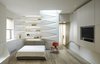 Modern home with Bedroom, Bookcase, Bed, Shelves, Wall Lighting, Recessed Lighting, and Medium Hardwood Floor. View towards the bedroom Photo of K Residence