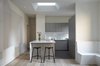 Modern home with Kitchen, Laminate Counter, White Cabinet, Medium Hardwood Floor, and Ceiling Lighting. View towards the kitchen Photo 3 of K Residence