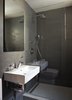 Modern home with Bath Room, Ceramic Tile Floor, Wall Mount Sink, Open Shower, Ceiling Lighting, and Stone Tile Wall. Bathroom Photo 6 of K Residence