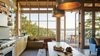 Modern home with Kitchen, Wood Cabinet, Dark Hardwood Floor, Pendant Lighting, Range, and Range Hood. Taking full advantage of sweeping views of Puget Sound, Hillside Sanctuary by Hoedemaker Pfieffer is sited on a small plateau high atop a steeply sloping hillside. Winter light penetrates deep into the living spaces through a wall of glass that runs continuously across the building’s south elevation. Photo 3 of Hillside Sanctuary