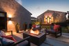 Modern home with Chair, End Tables, Sofa, Grass, Hardscapes, Shrubs, Raised Planters, Wood Patio, Porch, Deck, Concrete Patio, Porch, Deck, Decking Patio, Porch, Deck, Pavers Patio, Porch, Deck, Decomposed Granite Patio, Porch, Deck, Horizontal Fences, Wall, Wood Fences, Wall, Hanging Lighting, and Landscape Lighting. Backyard Seating & Fire Pit at Night Photo 15 of Del Rey Residence