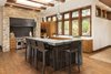 Modern home with Kitchen, Engineered Quartz Counter, Wood Counter, Granite Counter, Wood Cabinet, Medium Hardwood Floor, Stone Slab Backsplashe, Metal Backsplashe, Ceiling Lighting, Pendant Lighting, Recessed Lighting, Accent Lighting, Range Hood, Refrigerator, Microwave, Dishwasher, Range, and Undermount Sink. Custom Kitchen Photo 3 of La Jolla Modern
