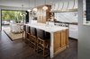 Modern home with Kitchen, Medium Hardwood Floor, Wood Cabinet, Marble Counter, Subway Tile Backsplashe, Pendant Lighting, Stone Slab Backsplashe, Recessed Lighting, Ceiling Lighting, Range, Range Hood, Dishwasher, and Undermount Sink. Kitchen Photo 3 of Mission Hills Modern