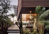 Modern home with Outdoor, Trees, Walkways, Shrubs, Side Yard, Metal Patio, Porch, Deck, Wood Fences, Wall, Hardscapes, Landscape Lighting, Decking Patio, Porch, Deck, Vertical Fences, Wall, Raised Planters, Metal Fences, Wall, Horizontal Fences, Wall, Flowers, Large Patio, Porch, Deck, Post Lighting, Wood Patio, Porch, Deck, and Gardens. The exterior deck seamlessly transitions into the interior of the home. Photo 3 of Skyline Residence