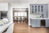 Modern home with Kitchen, Medium Hardwood Floor, Quartzite Counter, Colorful Cabinet, Wine Cooler, and Wall Oven. Custom Built-In Bar incorporated into great room Photo 3 of Danville Transitional Remodel